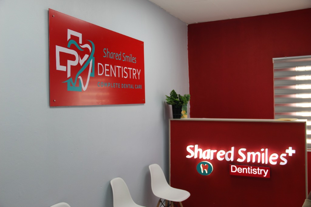 Shared Smiles Dentistry waiting area with brand signage